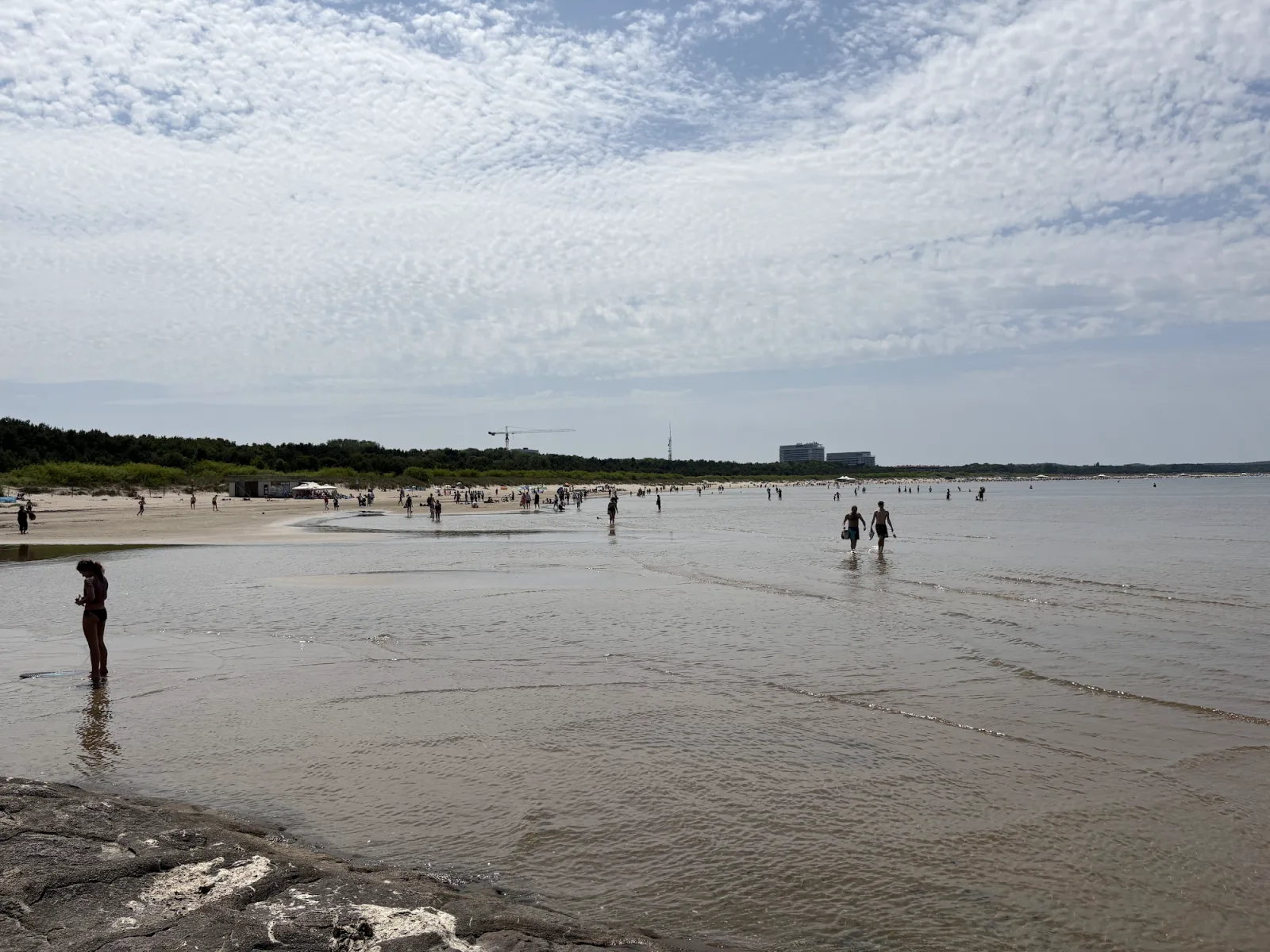 Breiter Sandstrand Plaża Świnoujście mit Badegästen und flachem Wasser bei Sonnenschein