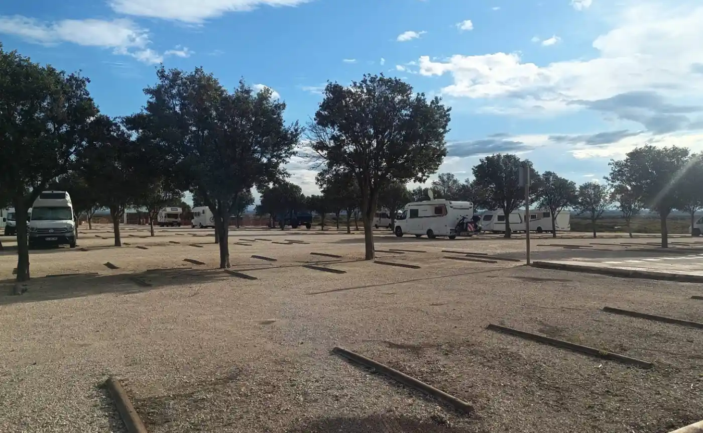 Kommunaler Wohnmobilstellplatz in Spanien mit markierten Parzellen und Bäumen